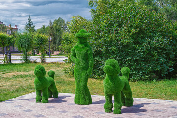 Figure of a woman with dogs in the public park