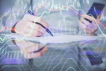 Double exposure of forex chart sketch hologram and woman holding and using a mobile device. Financial market concept.