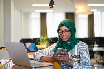 african muslim business woman using mobile phone