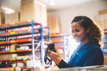 warehouse worker using bar code scanner to scanning box and analyze newly arrived goods for further placement in storage department, Working at warehouse.