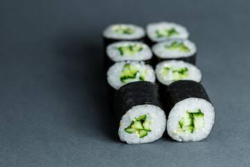Japanese food. Rolls with ripe cucumber, fresh rice with vegetables in nori. Vegetarian rolls