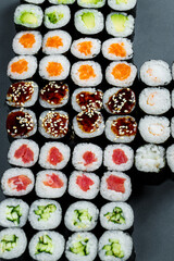 Japanese food. Rolls with ripe avocado, red fish, salmon, fresh rice with vegetables in nori. Set with rolls