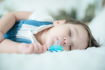 baby are sleeping on white bed at home