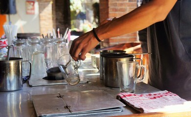 bartender pouring coffee into glass
