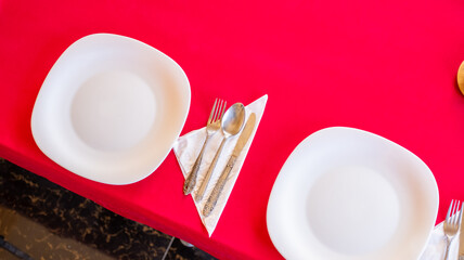 Table with empty plates being prepared for ramadan iftar