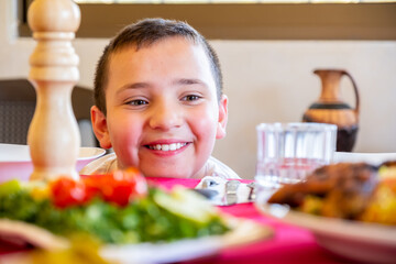Arabic boy enjoying family food together
