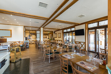 Interior of a hotel restaurant with wooden furniture