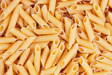 Close up of dry uncooked Penne pasta