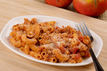 Delicious meal of elbow macaroni with pasta sauce and parmesan