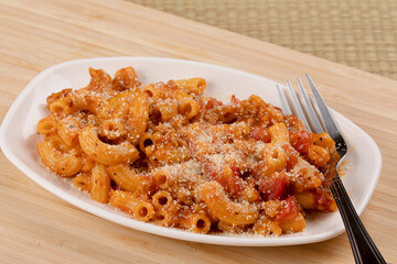 Delicious meal of elbow macaroni with pasta sauce and parmesan