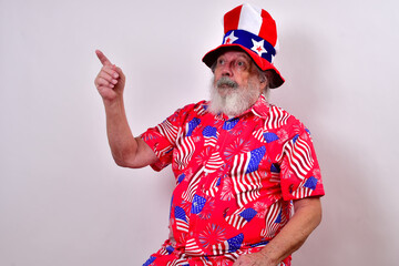 Patriotic old man has hand raised and is pointing.  .Man with a funny uncle sam hat and patriotic...