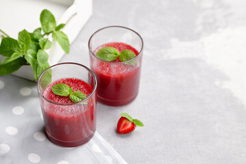 Homemade strawberry mousse in glasses with fresh mint leaves, summer berries dessert