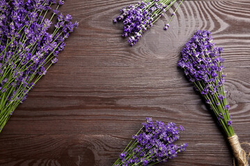 Natural lavender flowers bouquets flat lay on wooden background