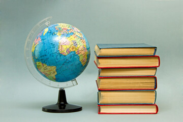 abstract symbol of study and knowledge. stack of books and globe. knowledge day, school and education.