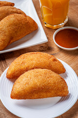 Brazilian appetizer deep fried beef croquette with pepper sauce and orange juice - Risolis