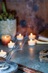 
rustic antique wooden still life with scented candle light and incense on work desk