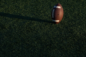 football on grass, ball bouncing in the air 