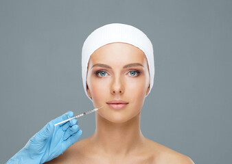 Doctor injecting in a beautiful face of a young woman. Plastic surgery concept.