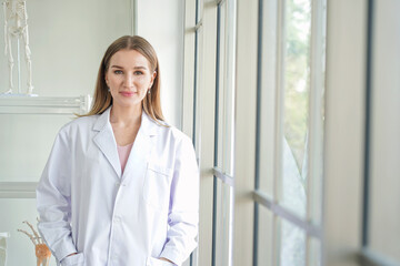 Female doctor wear white long lab coat in the laboratory room.