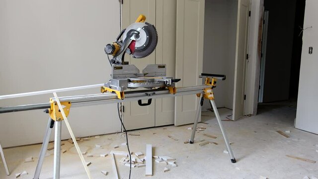 Interior construction of housing project with installed construction materials at work using circular saw cutting