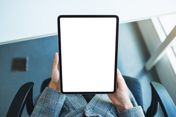 Top view mockup image of a business woman holding black tablet pc with blank white desktop screen