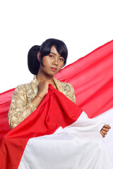 Beautiful Young Woman holds indonesian flag and looking to camera. Pretty woman wearing kebaya