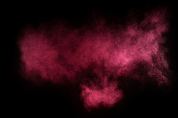 Obraz na płótnie Canvas Red and pink powder explosion on black background. Colored powder cloud. Colorful dust explode. Paint Holi.