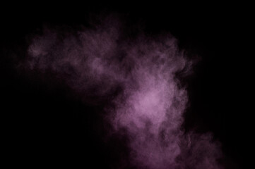 Purple powder explosion on black background. Colored powder cloud. Colorful dust explode. Paint Holi.