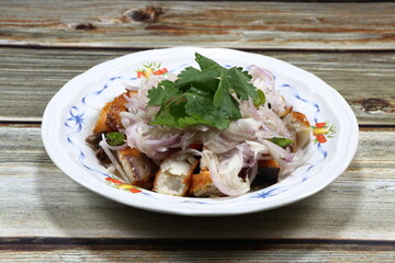 Traditional spicy salad of cutting Spanish mackerels with sliced fresh shallot and coriander. Seasoning with fish sauce, lime juice and chilly. Famous side dish with porridge in Asia restaurant. 