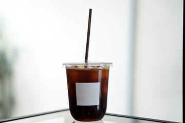 Iced americano - A glass of black coffee on table and copy space, The style of coffee prepared by brewing espresso and mixed with water.