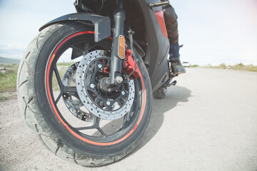 Motorcycle driver riding alone on asphalt motorway.