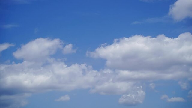 Fluffy White Clouds Moving In The Bright Blue Sky In The Afternoon - timelapse