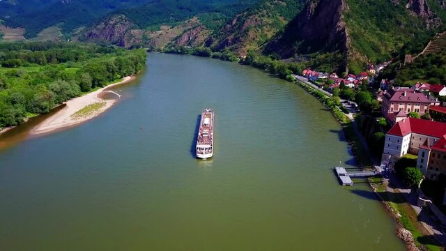 Aerial flyover a river cruise ship on the Danube in Austria. 4K