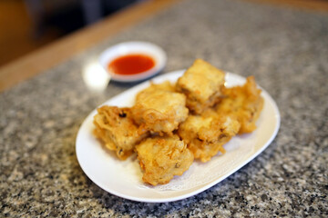 Deep fried homemade tofu with water chestnuts and mushrooms served with dipping sauce of chili and chinese coriander.