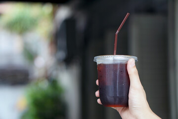 Iced americano - A glass of black coffee on table and copy space, The style of coffee prepared by brewing espresso and mixed with water.