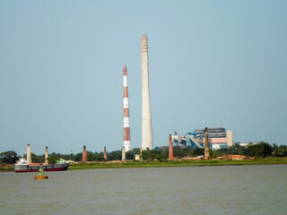 Obraz premium Riverside industrial park. Ganges Riverside Industrial District. Ganges river factories. Riverfront industrious village Urban landscape. Kolkata India South Asia Pacific