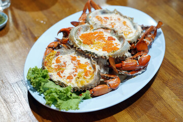 Boiled crab egg with milk - A plate of steamed black crab with crab's spawn (roe) and claw, Thai style seafood.