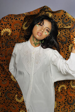 Beautiful Young Woman covering batik cloth on her body. fashion beauty portrait
