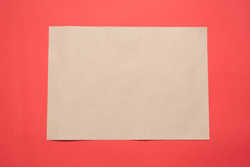 Blank paper page with copy space on the red flat lay background.
