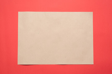 Blank paper page with copy space on the red flat lay background.
