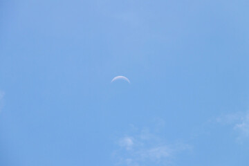 Crescent moon on blue sky. Look like a smile on a good day.