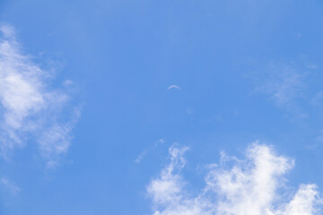Crescent moon on blue sky. Look like a smile on a good day.