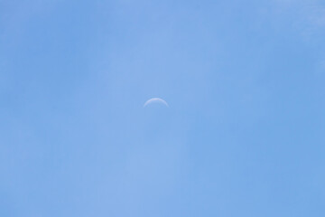 Crescent moon on blue sky. Look like a smile on a good day.
