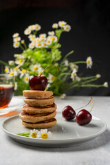 The trendy food during the Covid-19 coronavirus quarantine is tiny pancakes. Poffertjes,. Children's breakfast, mini pancakes. Vertical orientation