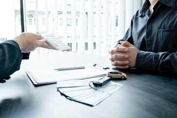 The car dealer advises the customer about insurance details and car rental information Ready...