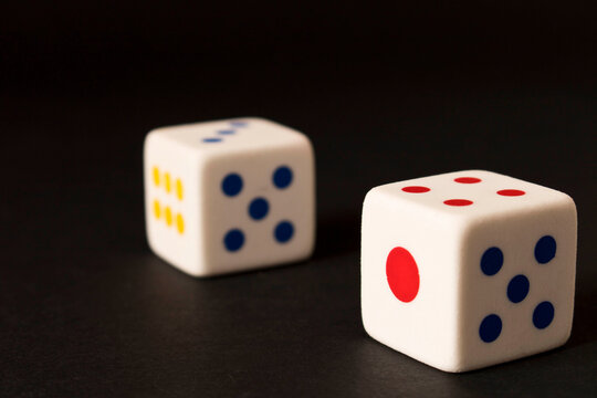 Dice on the dark background. Close up. The concept of good luck in gambling.