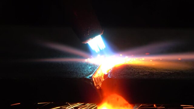 Closeup of Track Burner melting through metal as sparks fly