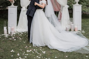 Fototapeta premium groom with bride near the arch of the wedding