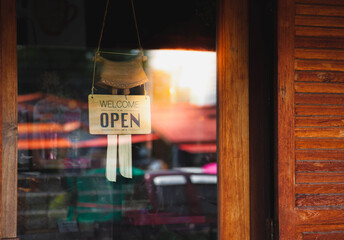 Text on vintage wooden sign "WelCome we're open please come in", Cafe.
