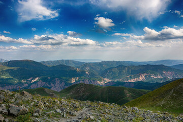 Naklejka premium Idyllic summer landscape with hiking trail in the mountains with beautiful fresh green mountain pastures.